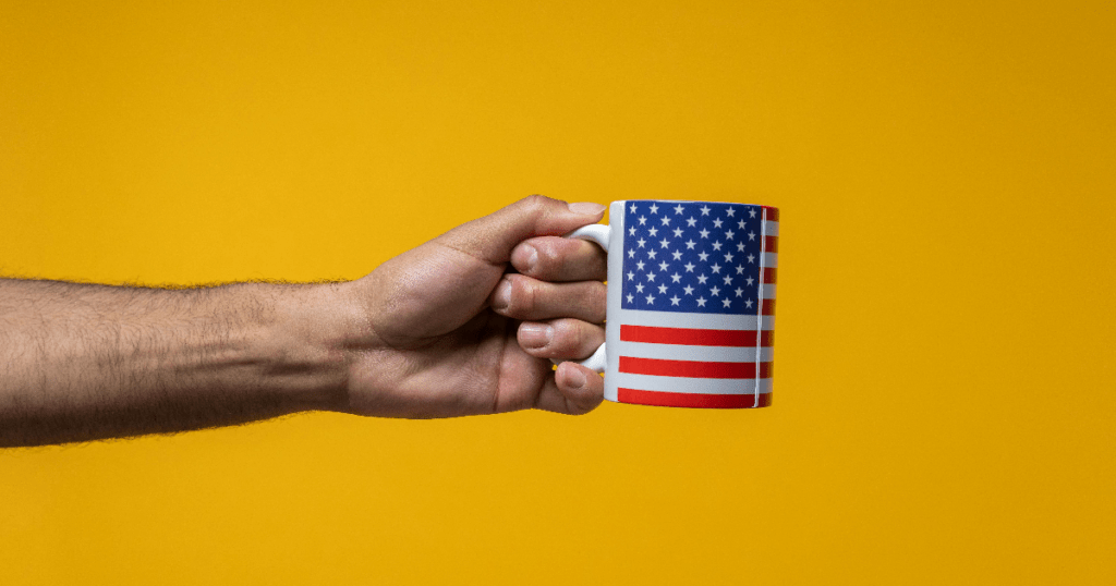 Man holding coffee mug with USA flag design