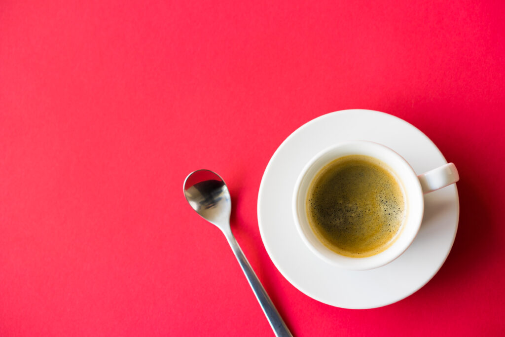 espresso in cup on a saucer with a spoon