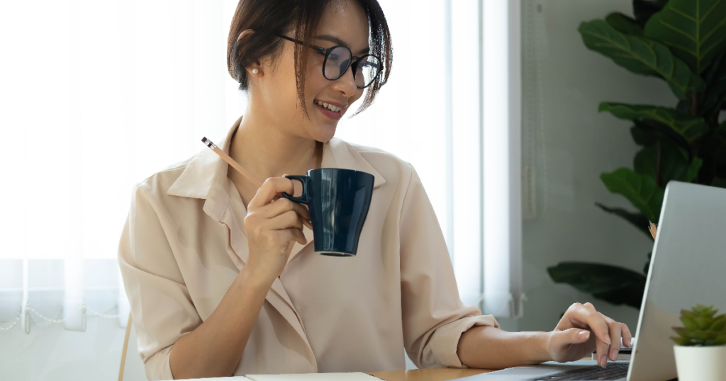 Woman enjoying bean to coffee machine beverage while working in an office